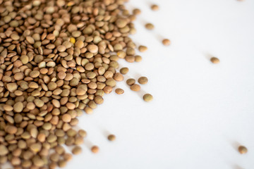 brown lentils on white surface