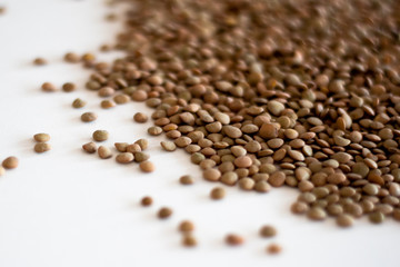 brown lentils on white surface