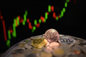 Bitcoins and virtual money concept. Gold bitcoins on a stack of coins 
