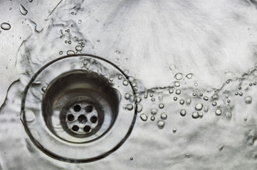 a wet dirty sink after washing many dishes photo may had noise and gain