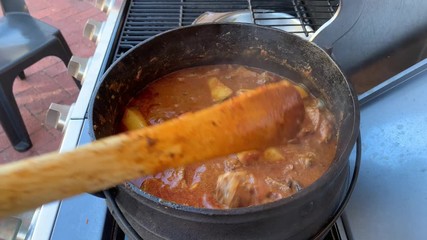 Making a lamb curry potjie food