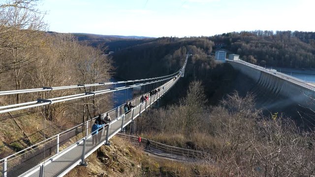 visitors walking on the Titan RT bridge in the Harz Mountains, Germany. panning up