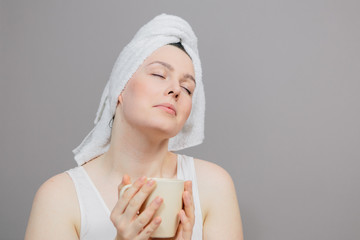 Girl with a towel on her head and a cup, happy girl