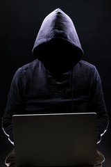 a shady figure that could represent a criminal, a hacker, ambiguity and duplicity