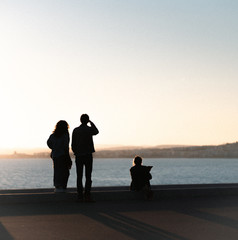 family on the beach at sunset
