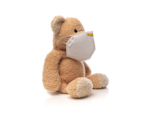 Teddy bear with protective medical face mask on white.