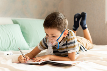 Stay at home quarantine coronavirus pandemic prevention. The child does his homework during treatment with a nibulizer. Prevention epidemic. COVID-19.