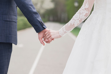 bride and groom holding hands