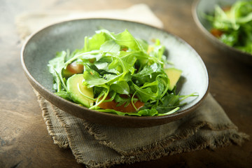 Healthy arugula salad with tomato and avocado