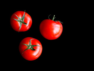 Bunch of tomatoes on dark slate background. Healthy food concept. Close up. Macro