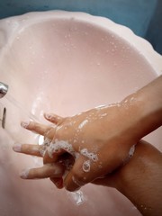 Fototapeta premium young woman washing her hands with handwash,soap