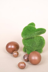 Easter eggs hunt - bunny with egg on wooden background