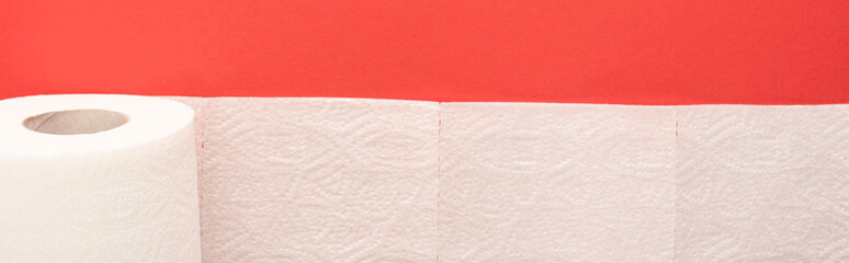 top view of white toilet paper roll on red background, panoramic shot