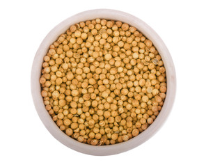 Coriander seeds on wooden bowl isolated on white background