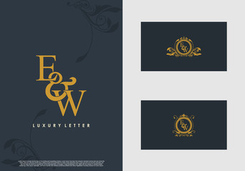 EW logo initial vector mark. Gold color elegant classical symmetric curves decor.