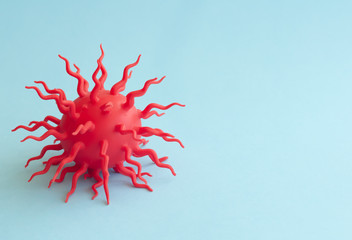 Covid-19 blue abstract background. Dangerous Coronavirus distribution model and hand. Pandemic COVID-19. Close up. Copy space