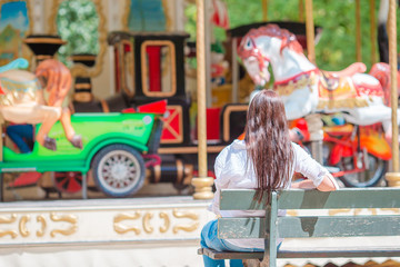 Beautiful woman near the carousel outdoors in Paris