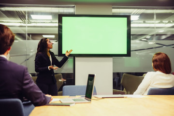 Confident speaker talking and pointing at display. Experienced analyst during presentation. Business conference concept