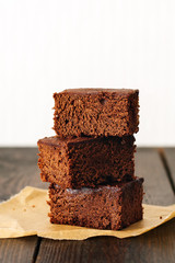 Brownie, chocolate cake on a dark rustic wooden table