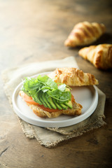 Croissant sandwich with tomato and avocado