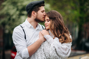 Fototapeta premium man kissing his girlfriend on the forehead