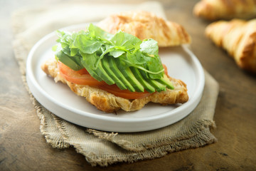 Croissant sandwich with tomato and avocado