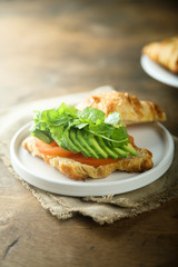 Croissant sandwich with tomato and avocado