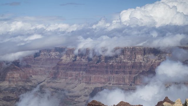 A stunning long-lens timelapse of clouds flowing around and over the distant South Rim of the Grand Canyon.