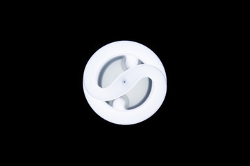 Energy saving fluorescent light bulb, isolated black background