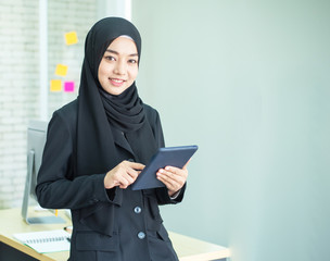 young woman muslim work in office using phone