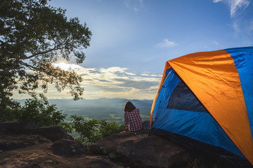 Tourists pitch a tent on the cliff.