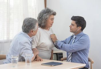 Health visitor and a senior woman during home visit.