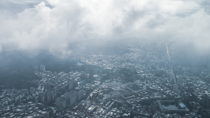 Fototapeta premium The view across Taipei, captial of Taiwan, from the top of Taipei 101, the second largest building in the world,shoot after raining with fog.