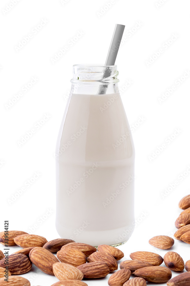 Wall mural glass bottle of almond milk with straw isolated on white background