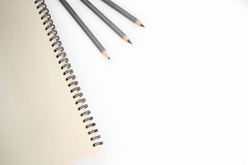 Notebook and simple pencils on a white background