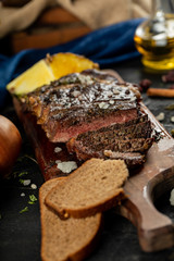 Sliced meat barbecue served with bread slices