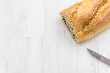Loaf of bread cut in half and knife
