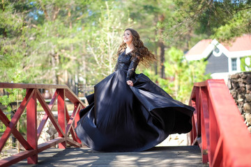 beautiful girl in a black dress in the park