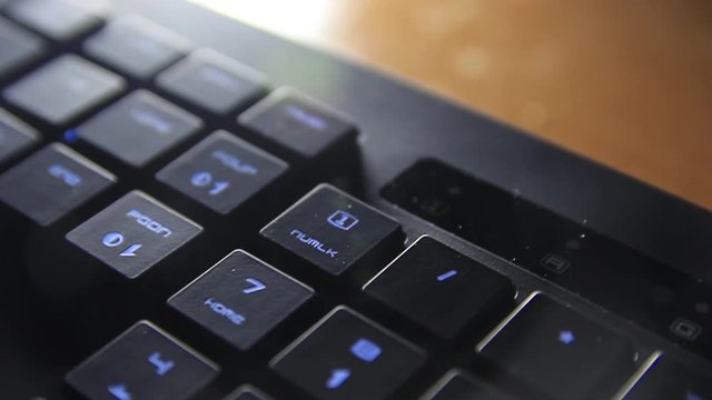 the female finger presses a button on the keyboard and it changes colors.