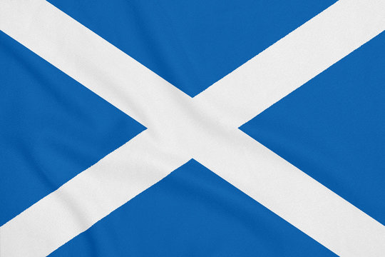 Flag of Scotland on soft and smooth silk texture. National symbol of Scotland.