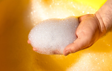 Fototapeta premium hand washing in water with soap suds