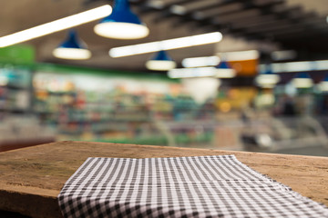 Supermarket background, Counter over blur grocery background, Wooden desk, table, shelf and blur woman shopping at supermarket, Wood counter for grocery store retail product display backdrop, template