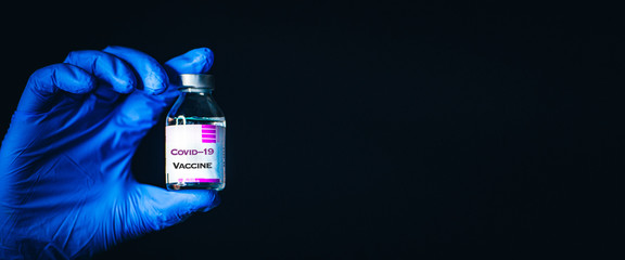Coronavirus Protection and Vaccine. Medicine bottle for injection in hand, palm of a doctor....