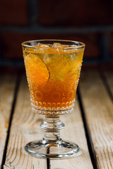classic old fashion cocktail on a wooden background with lines