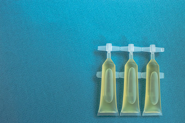 medical capsules with a vaccine on a blue background