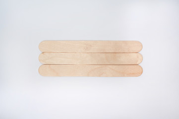 wooden sticks for depilation and sugaring on white background