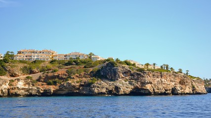 Fototapeta na wymiar Beautiful coast of Mallorca/Majorca - Majorca coastline with caves in the rocks - view from the cruise ship, from the sea