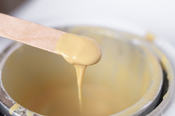 wax  and wooden stick on white background depilation remove hair