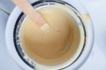 wax  and wooden stick on white background depilation remove hair