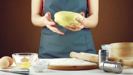 female cook kneads the dough on a wooden table. homemade baking - Powered by Adobe